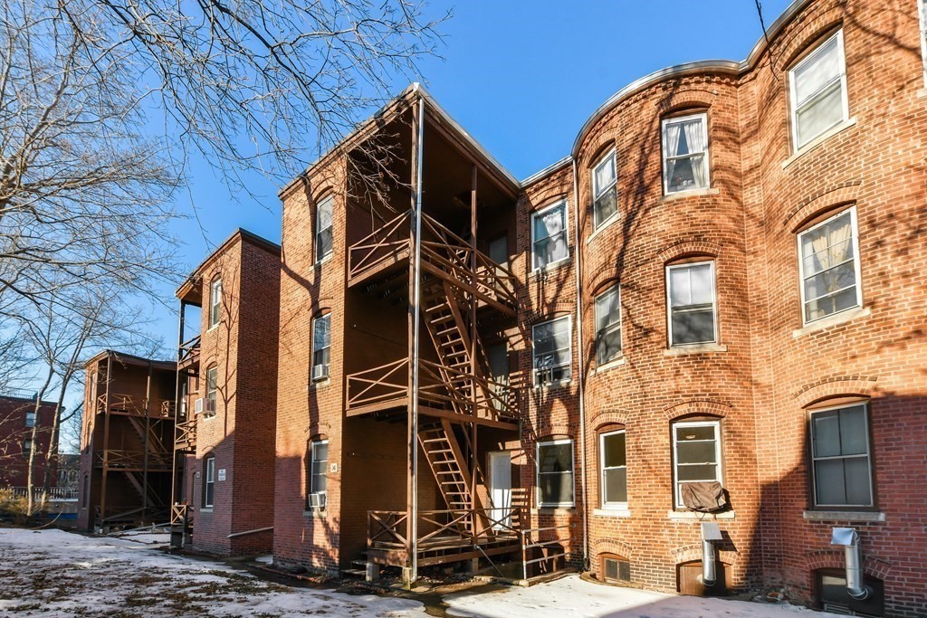 36 Winchester Street, Unit 2 Brookline, MA 02446 - Photo 13 of 18 a view of a blue house with many windows