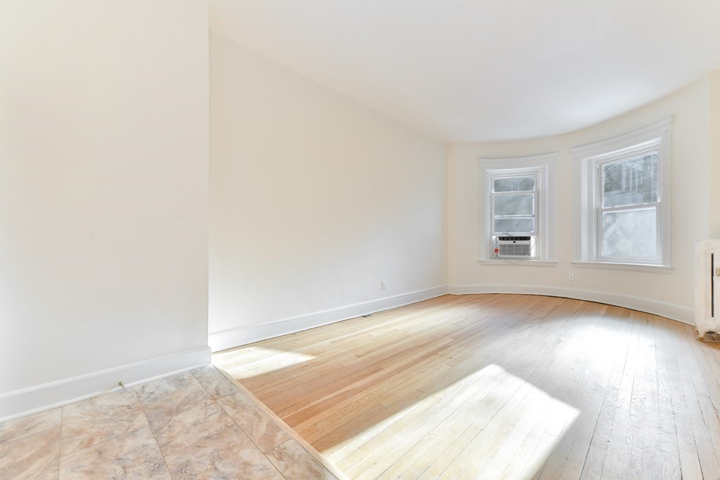 36 Winchester Street, Unit 2 Brookline, MA 02446 - Photo 3 of 18 an empty room with wooden floor and windows