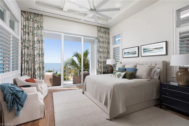 a bedroom with a bed and large window