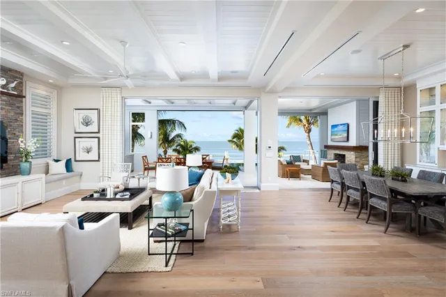 a living room with furniture dining table and a large window