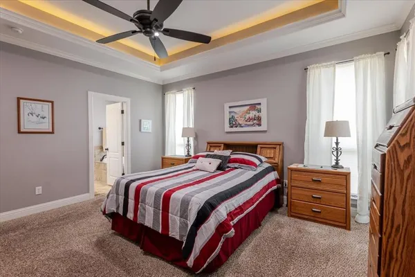 a bed room with a bed and a ceiling fan