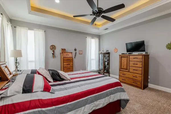 a bedroom with a bed and a flat tv screen