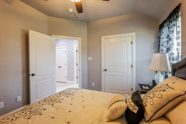 a bedroom with a bed and a chair