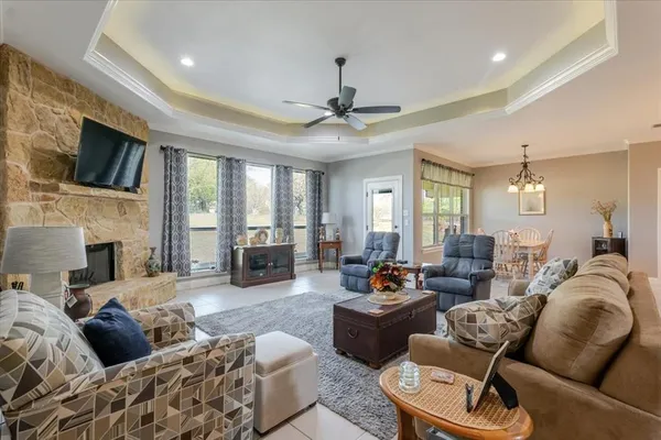 a living room with furniture ceiling fan and a fireplace