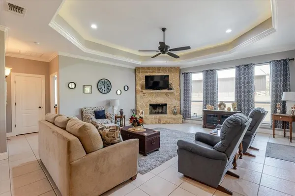 a living room with fireplace furniture and a large window