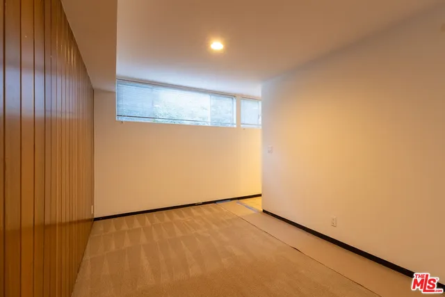 a view of an empty room and a window