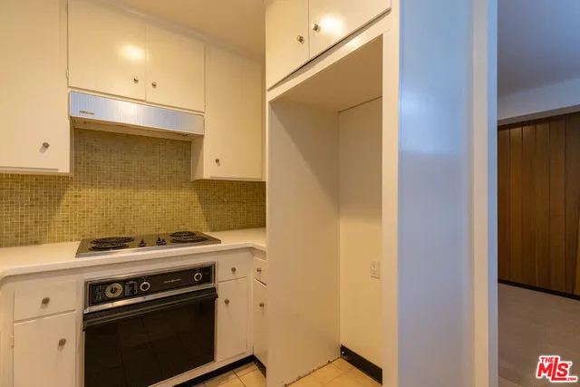 a kitchen with a stove and a microwave