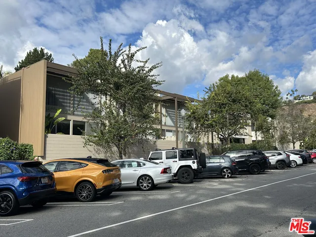 a view of cars parked in front of a building