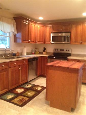 4 Randall Road Berlin, MA 01503 - Photo 2 of 13 a kitchen with stainless steel appliances granite countertop a stove a sink a microwave and cabinets