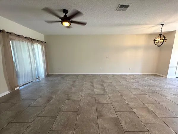 a view of empty room with ceiling fan