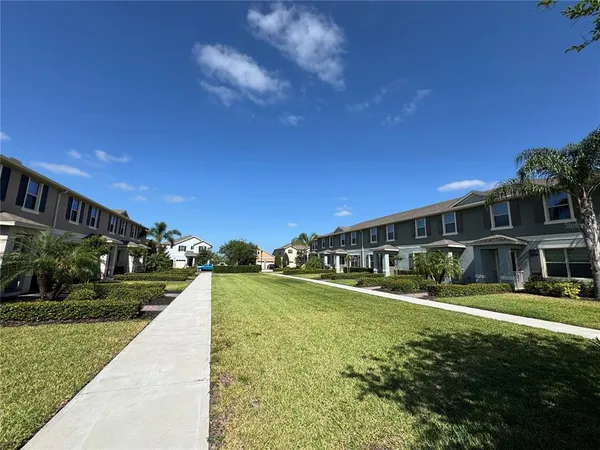 a view of house with yard and green space