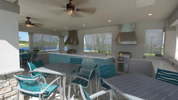 a kitchen with stainless steel appliances kitchen island granite countertop a sink table and chairs