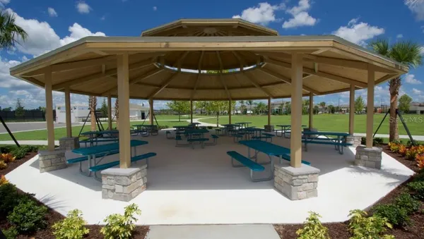 a view of patio with a table and chairs under an umbrella