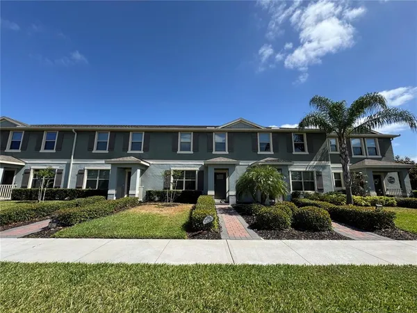 a front view of a residential apartment building with a yard