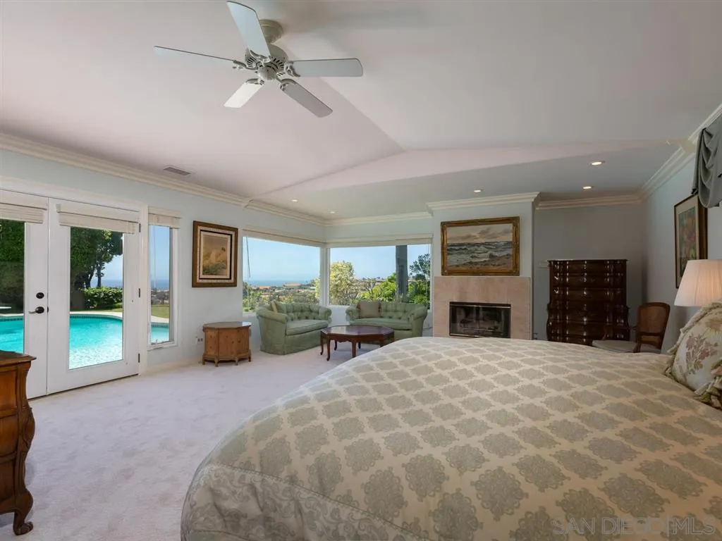 5486 Soledad Road La Jolla, CA 92037 - Photo 13 of 25 a view of a livingroom with a fireplace a window and a couch