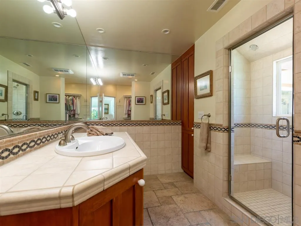 5486 Soledad Road La Jolla, CA 92037 - Photo 15 of 25 a bathroom with a sink and a mirror