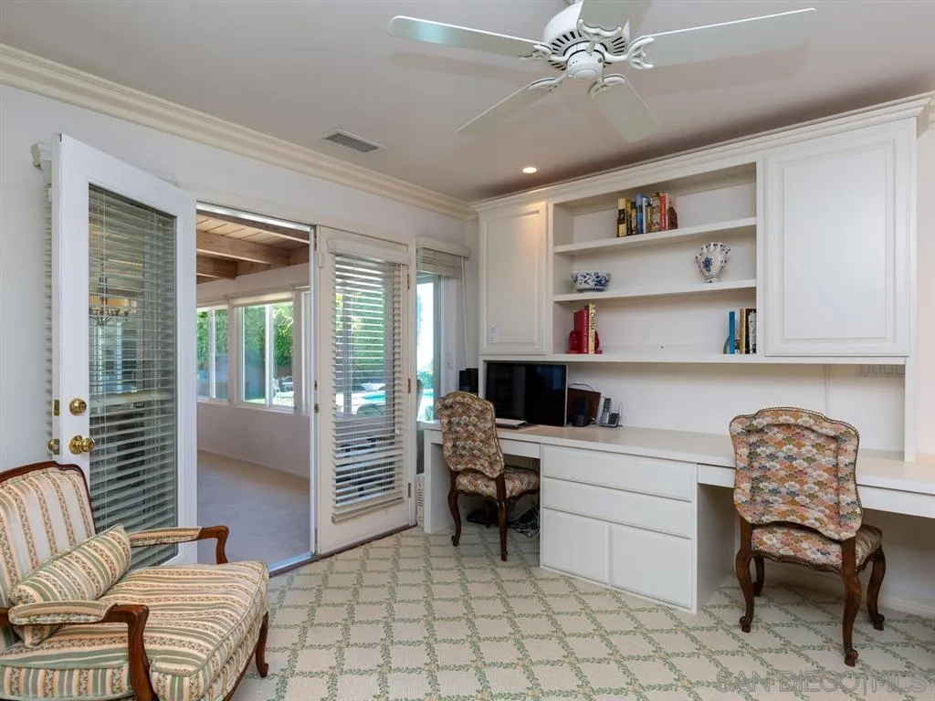 5486 Soledad Road La Jolla, CA 92037 - Photo 16 of 25 a room with a chair and a chandelier