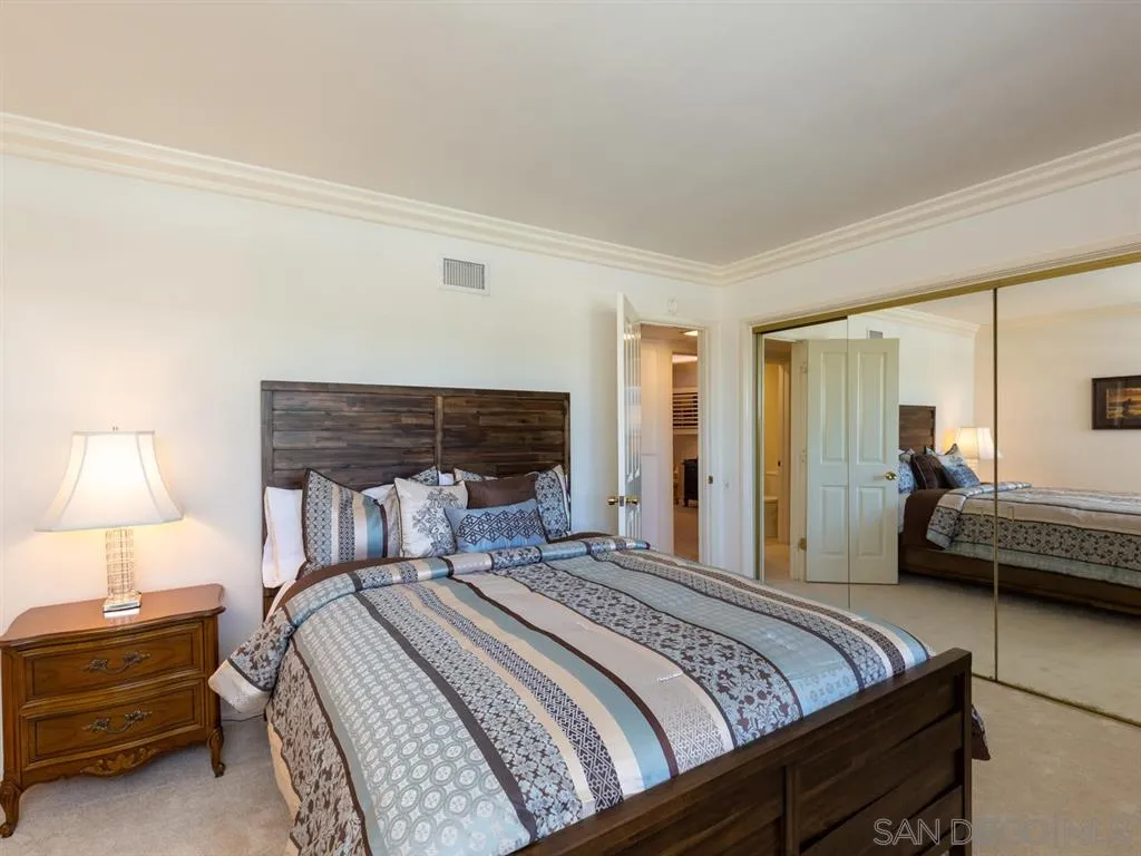 5486 Soledad Road La Jolla, CA 92037 - Photo 19 of 25 a bedroom with a bed and a night stand