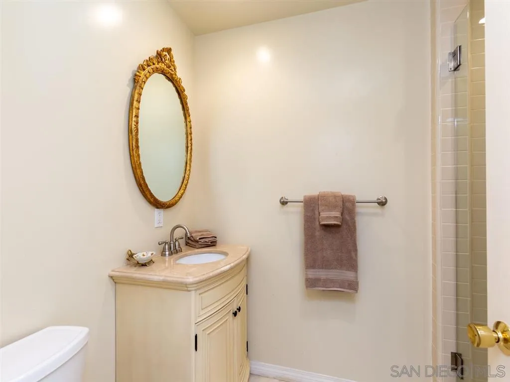 5486 Soledad Road La Jolla, CA 92037 - Photo 23 of 25 a bathroom with a sink a mirror and a toilet