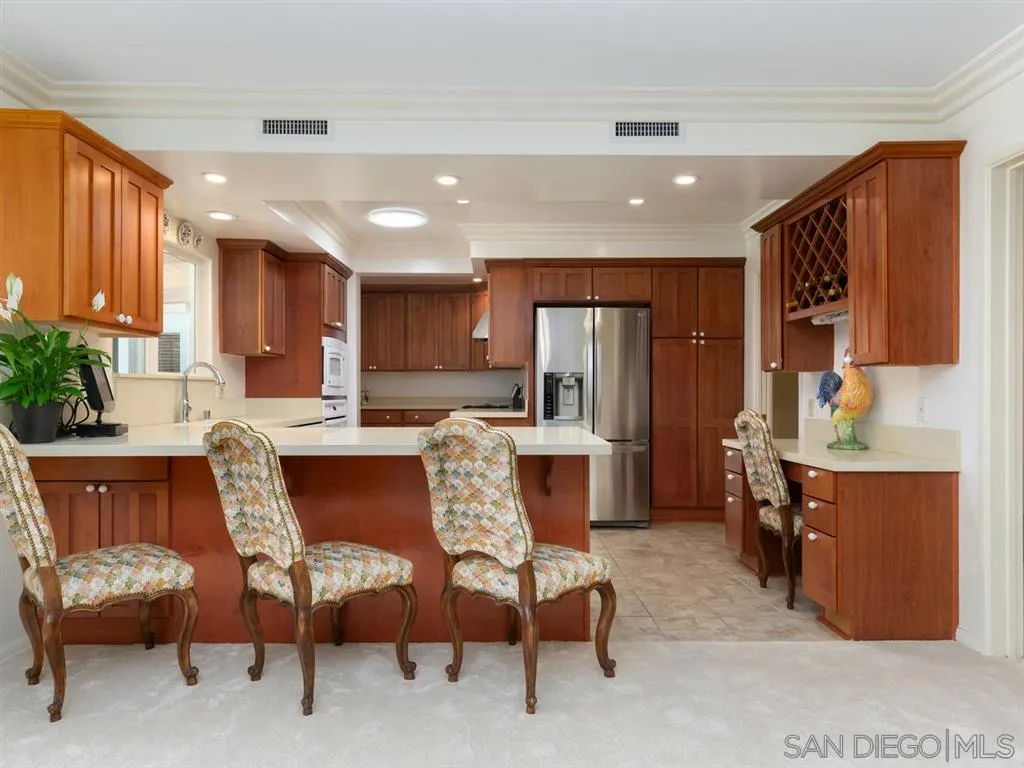5486 Soledad Road La Jolla, CA 92037 - Photo 8 of 25 a dining room with furniture a window and kitchen view
