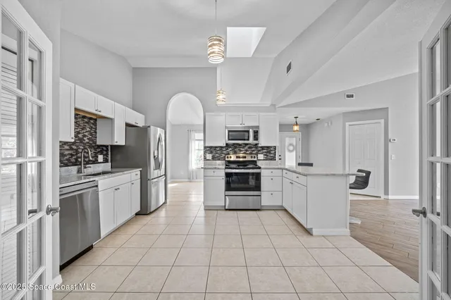 a view of an empty room with a fireplace and a window