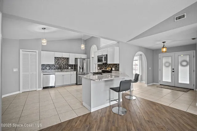 a bedroom with a bed and a potted plant