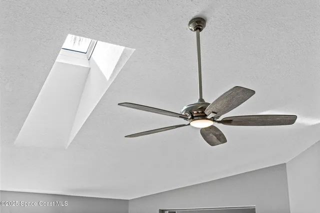 a bathroom with a granite countertop sink a large mirror and a bathtub next to a window