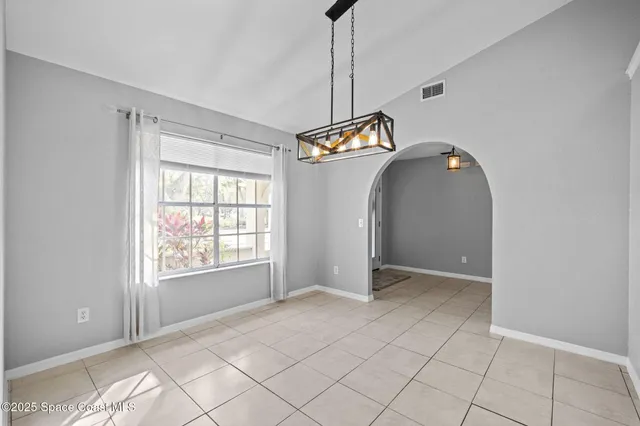 a kitchen with stainless steel appliances kitchen island granite countertop a refrigerator and cabinets