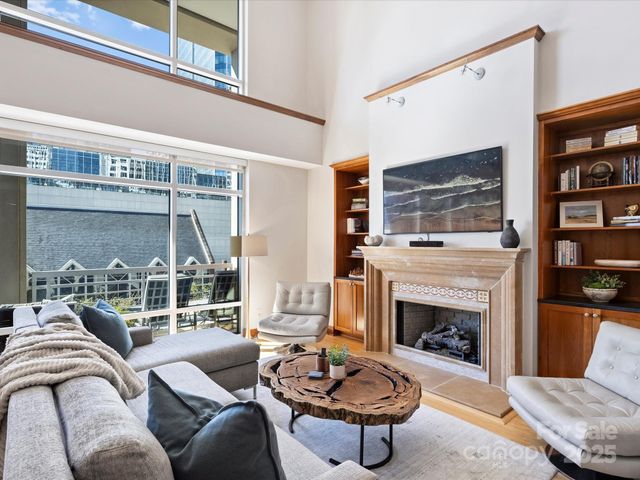 a living room with furniture a rug and a fireplace