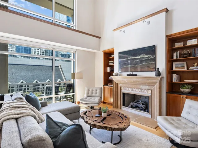 a living room with furniture a rug and a fireplace