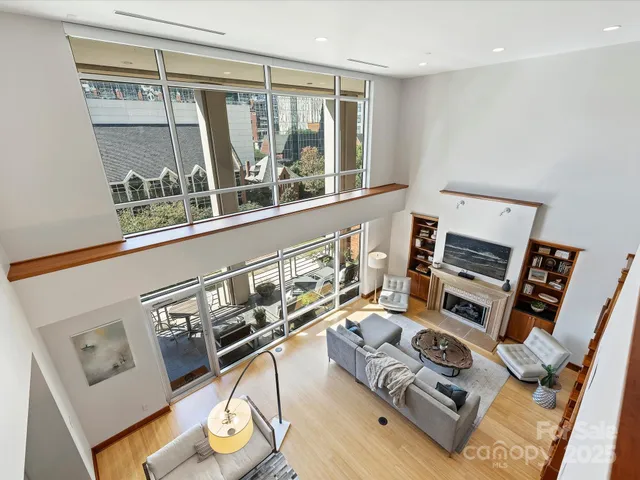 a living room with furniture and a floor to ceiling window