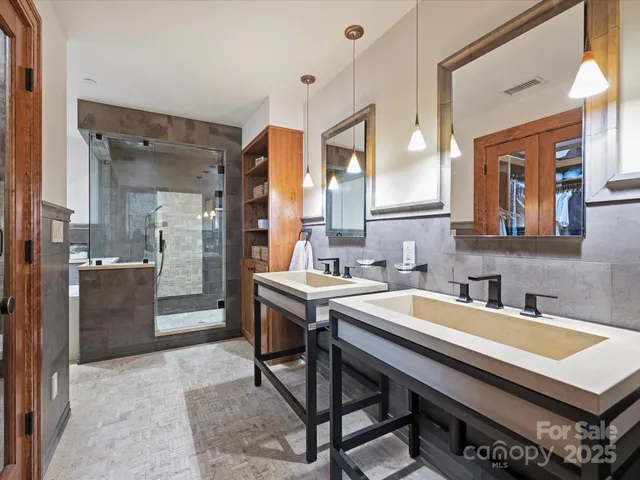 a room with a table chairs and a kitchen view