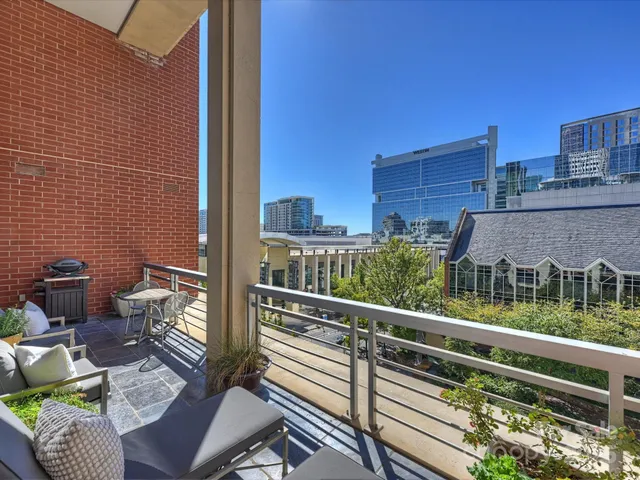 a view of balcony with two chairs and a rug