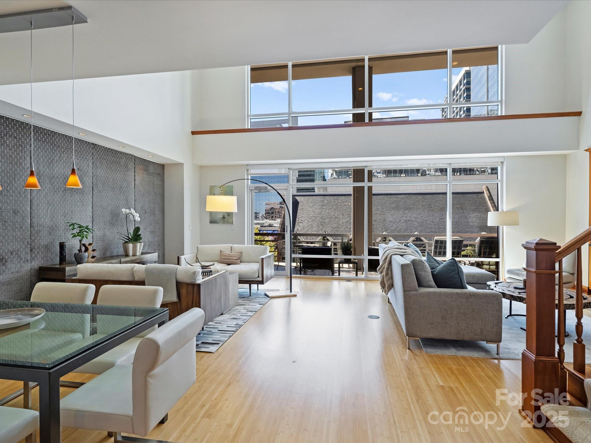 435 South Tryon Street, Unit 307 Charlotte, NC 28202 - Photo 5 of 48 a living room with furniture and wooden floor