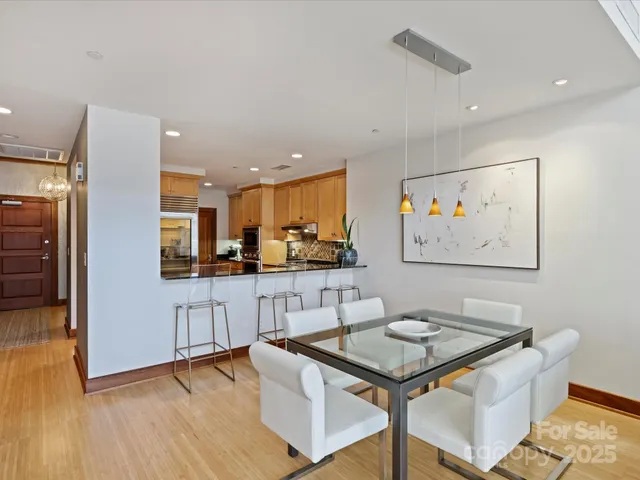 a kitchen with stainless steel appliances granite countertop a stove a sink a refrigerator and a microwave