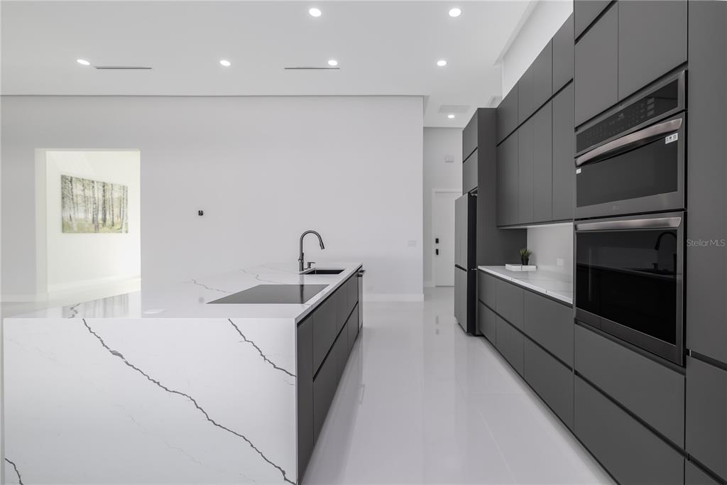 6 Rockne Lane Palm Coast, FL 32164 - Photo 18 of 24 a kitchen with stainless steel appliances a refrigerator sink and stove