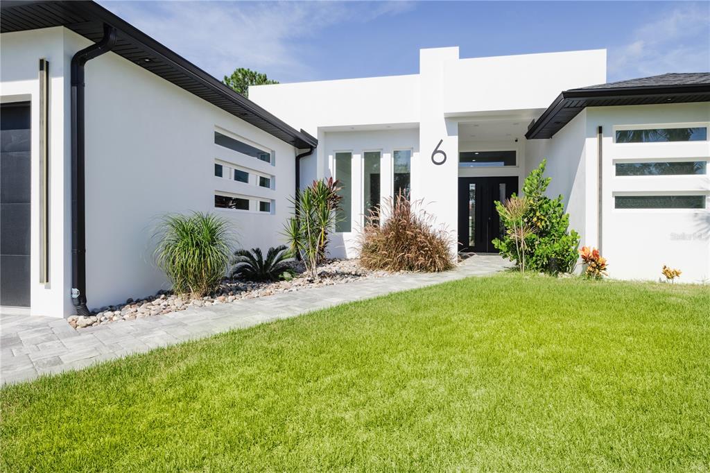6 Rockne Lane Palm Coast, FL 32164 - Photo 5 of 24 a front view of a house with a yard