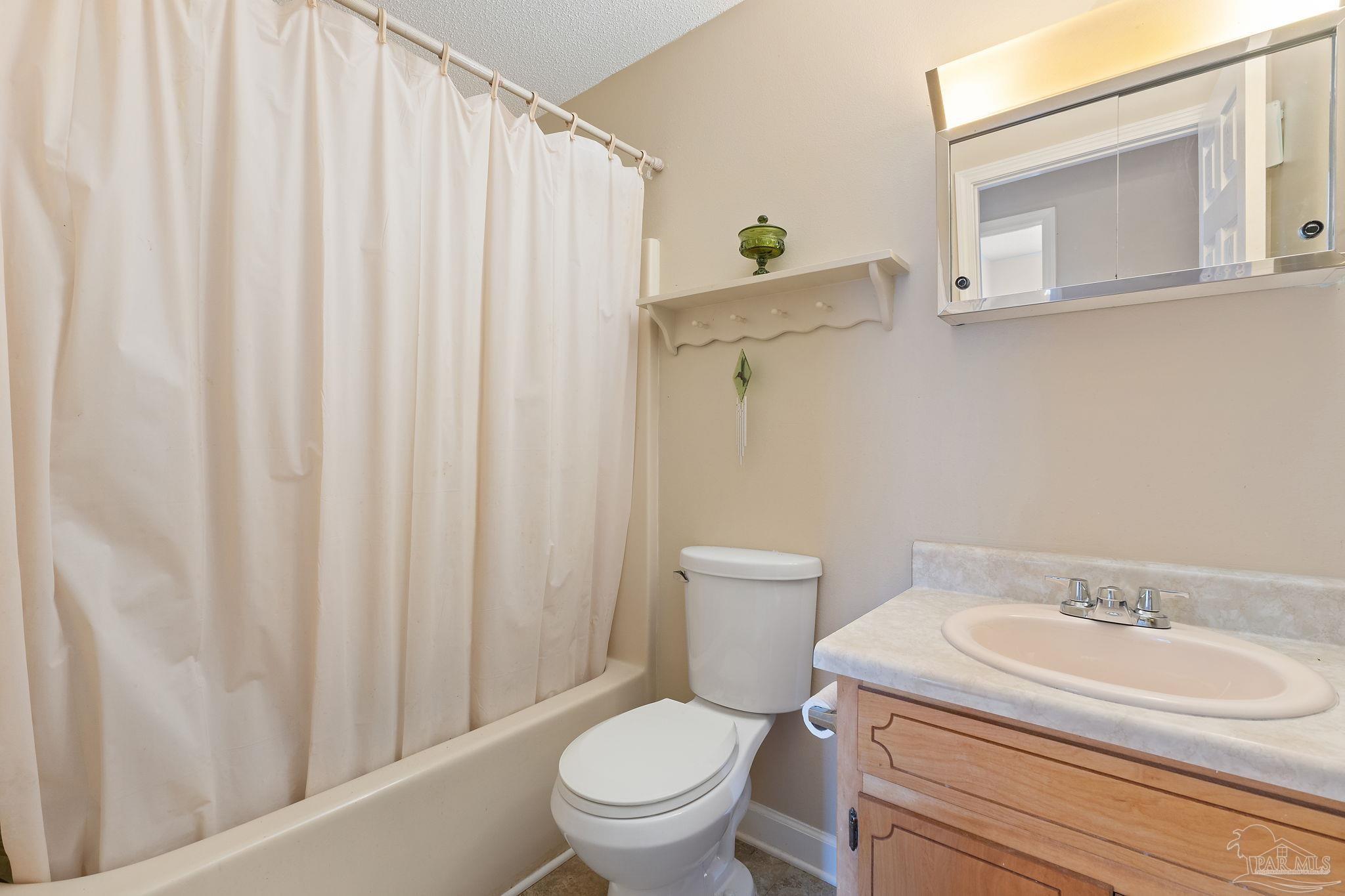 2329 Camors Road Jay, FL 32565 - Photo 14 of 28 a white toilet sitting next to a bathroom sink