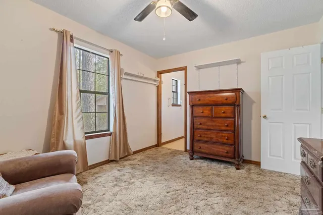 an empty room with furniture and windows