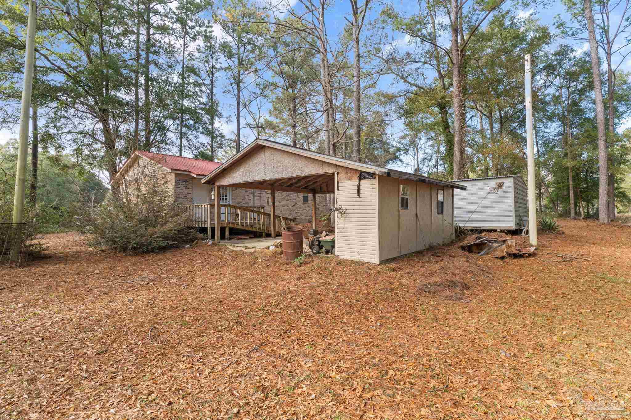 2329 Camors Road Jay, FL 32565 - Photo 23 of 28 a house with trees in the background