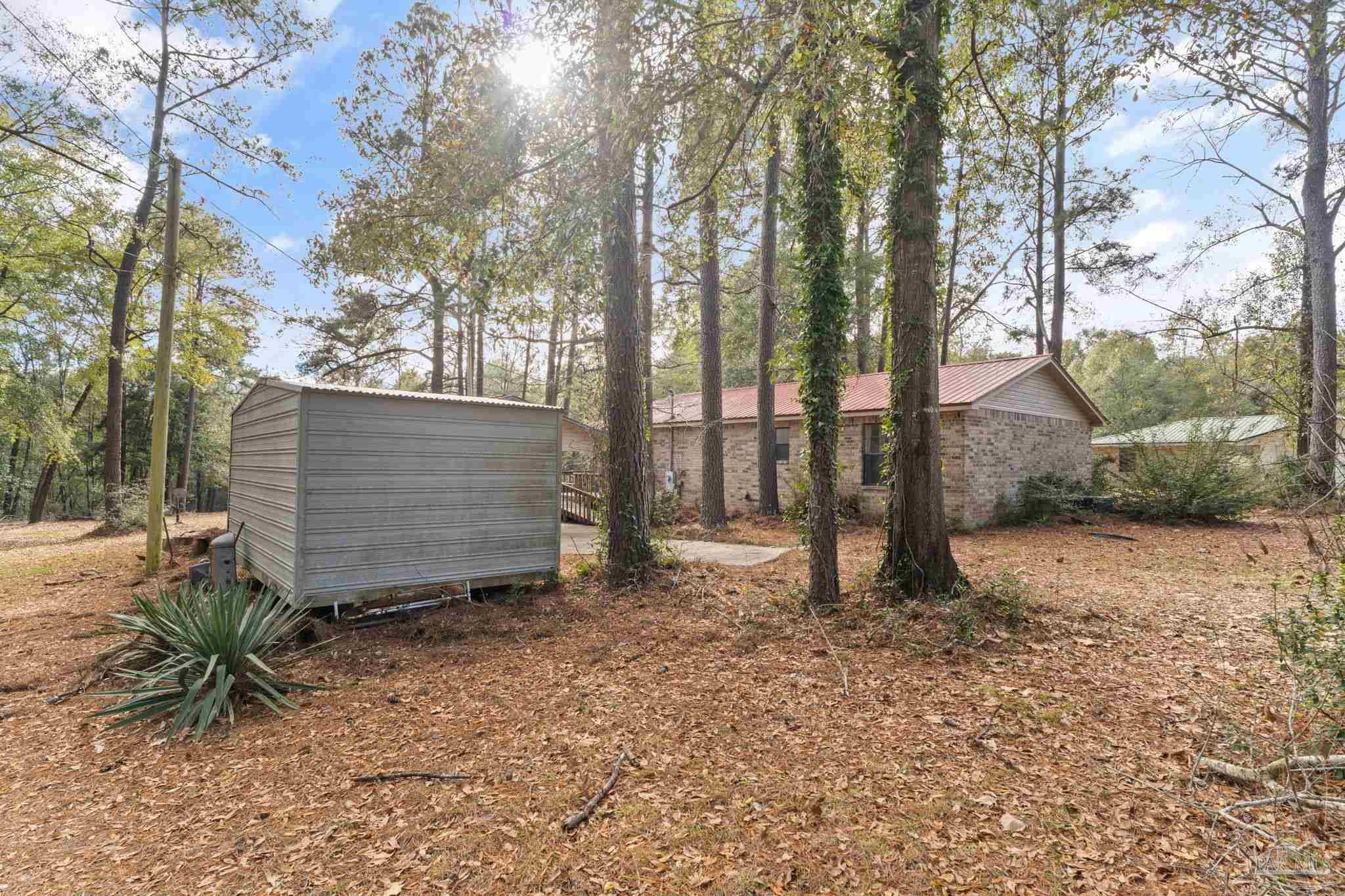 2329 Camors Road Jay, FL 32565 - Photo 24 of 28 a view of a barn in the middle of a yard