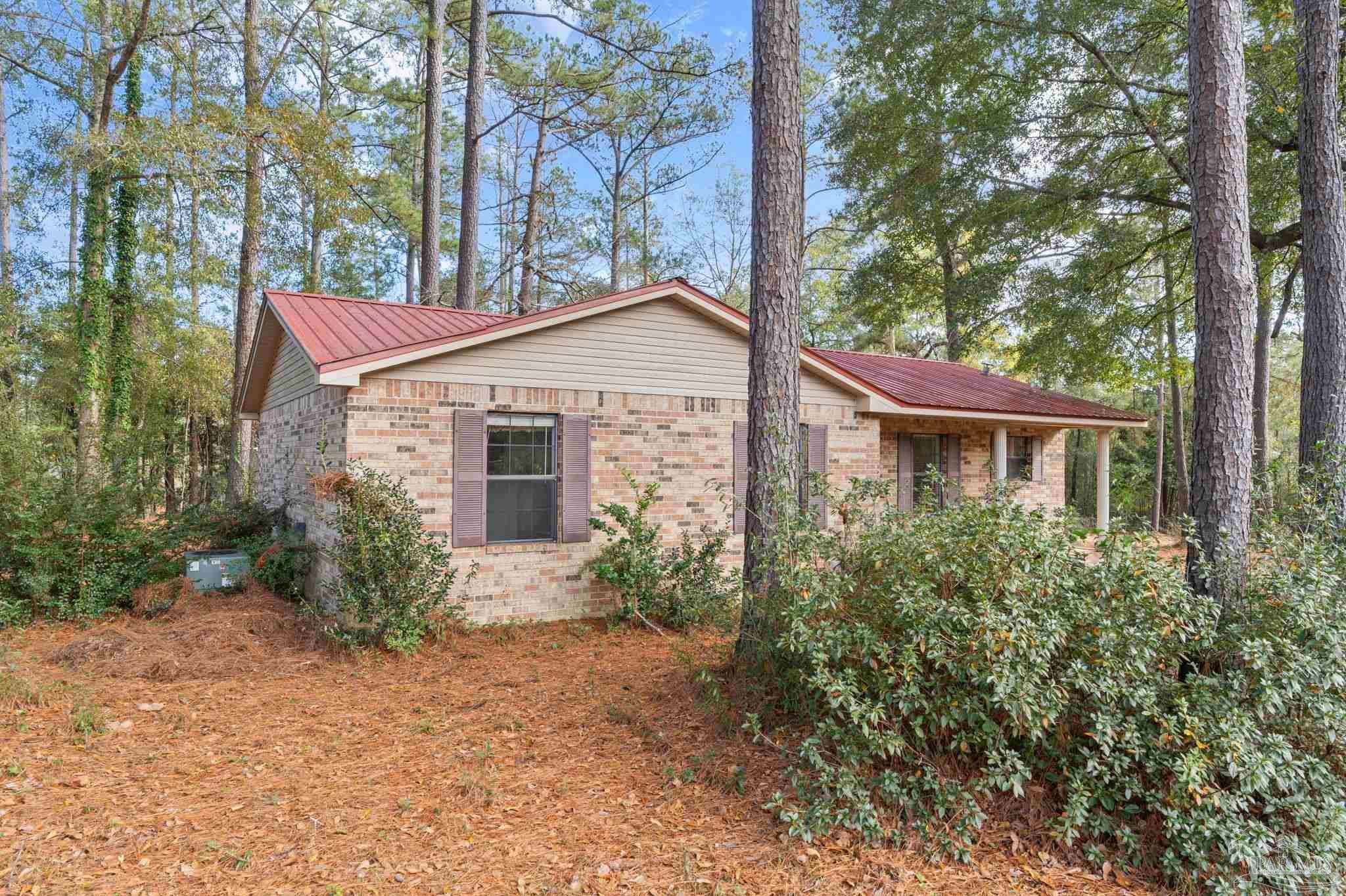 2329 Camors Road Jay, FL 32565 - Photo 4 of 28 a front view of house with yard and trees
