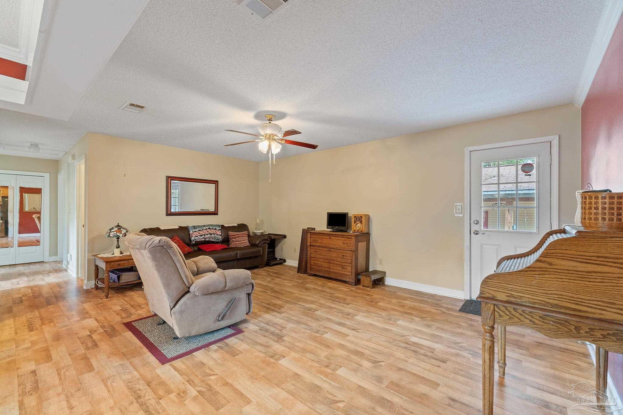 2329 Camors Road Jay, FL 32565 - Photo 8 of 28 a living room with furniture and a wooden floor