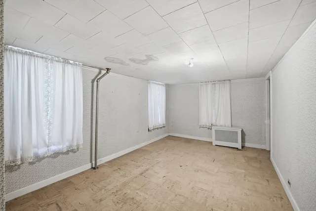 an empty room with white wall and door