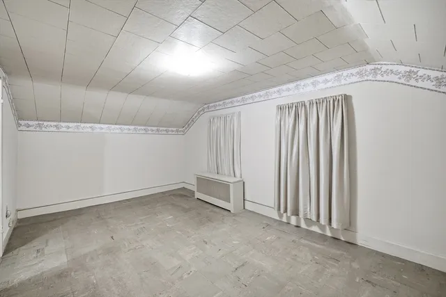 a view of a hallway with a white walls and stairs