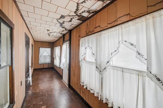 a backyard of a house with barbeque oven and outdoor seating