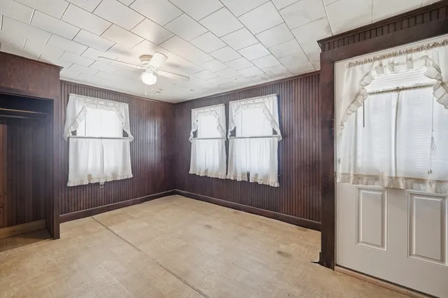 an empty room with windows and closet