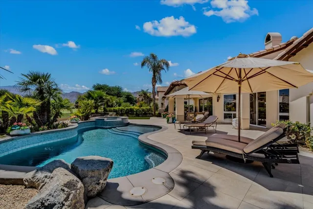 an aerial view of a house with garden space and swimming pool