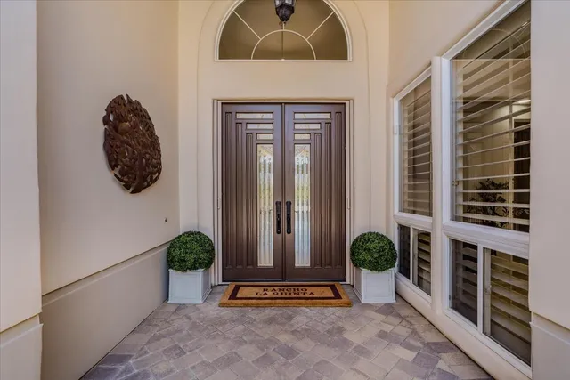 an aerial view of a house with a garden and lake view