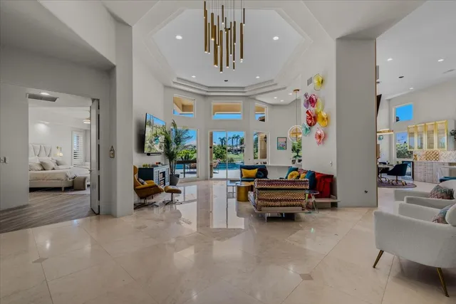 a kitchen with stainless steel appliances granite countertop a sink a counter top space and living room view